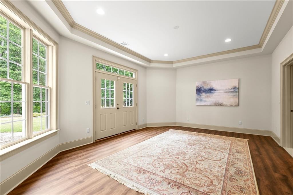 322 Edwards Brook Lane Canton, GA 30115 - Photo 82 of 99 a view of an empty room with wooden floor and a window