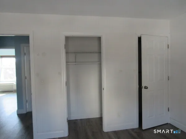 a view of hallway with wooden floor