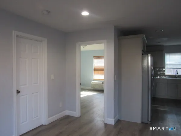 a view of hallway with wooden floor