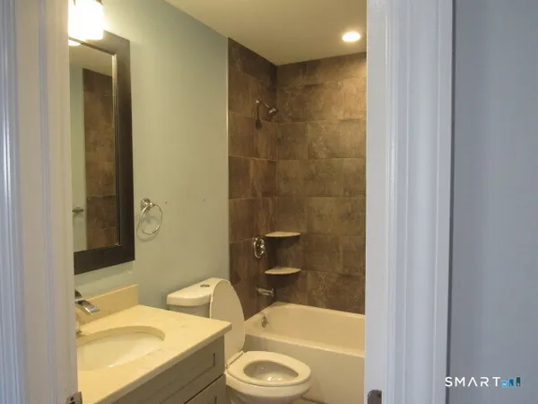 a bathroom with a tub a sink and a toilet