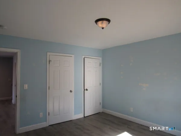 an empty room with wooden floor