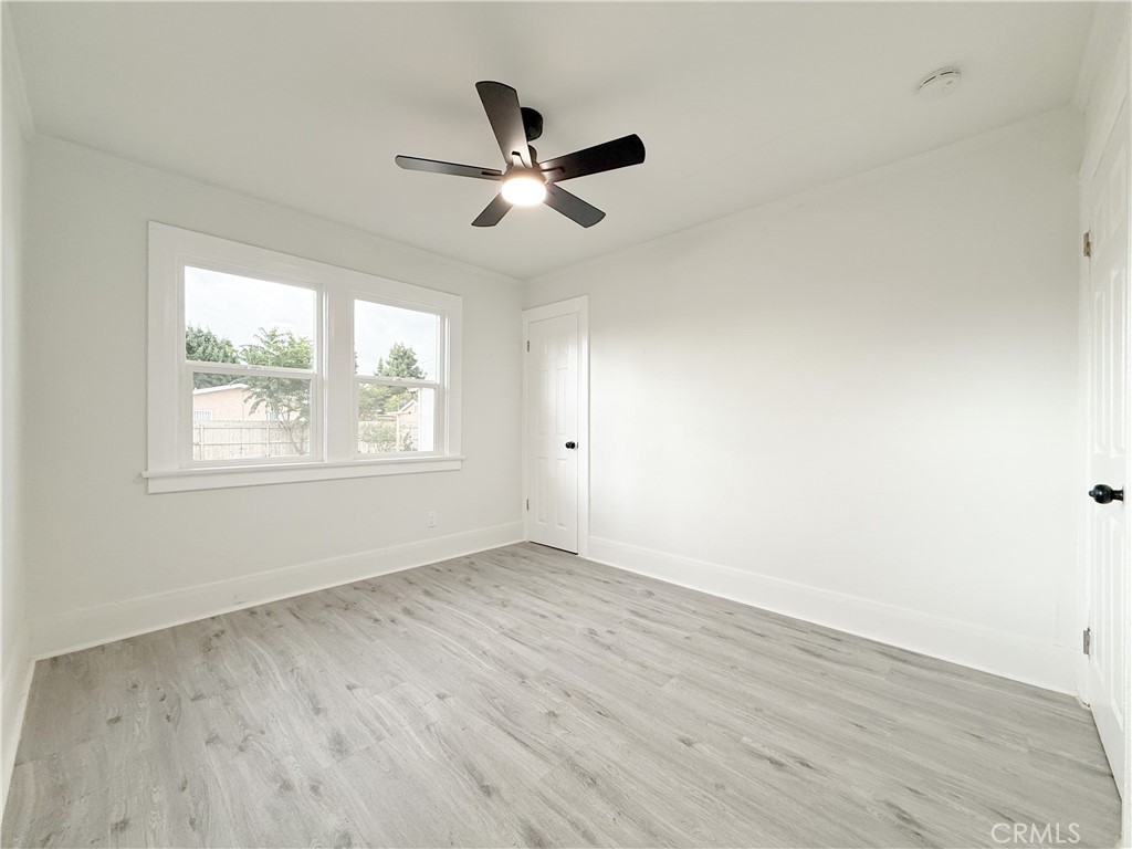 2222 East 124th Street Compton, CA 90222 - Photo 16 of 20 a view of empty room with wooden floor and fan