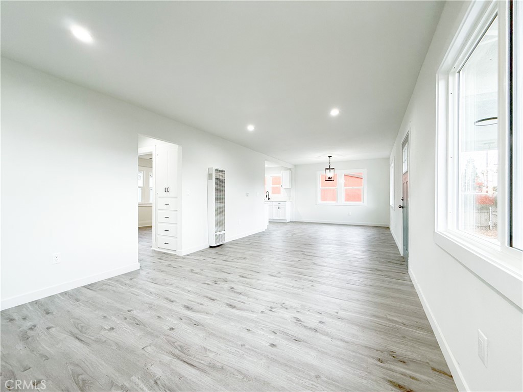 2222 East 124th Street Compton, CA 90222 - Photo 5 of 20 an empty room with wooden floor and windows