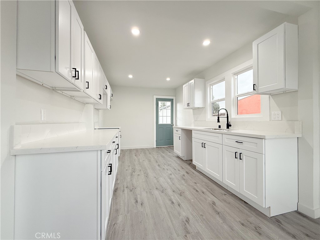 2222 East 124th Street Compton, CA 90222 - Photo 8 of 20 a kitchen with cabinets oven and a sink