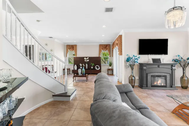 a living room with furniture a flat screen tv and a fireplace