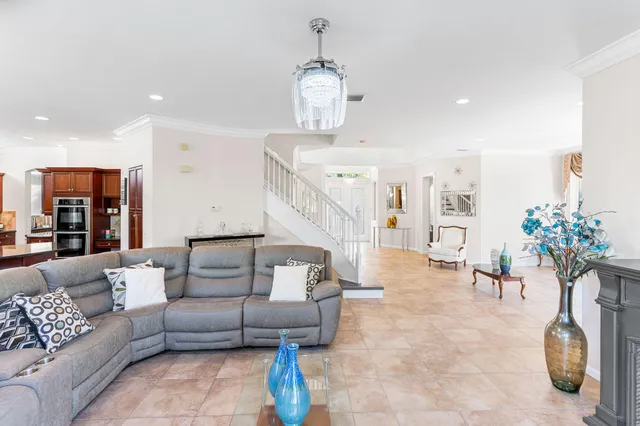 a living room with furniture and a chandelier