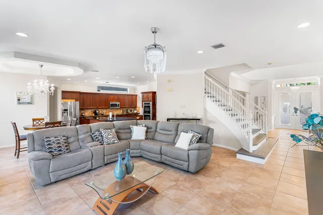 a living room with furniture and a chandelier