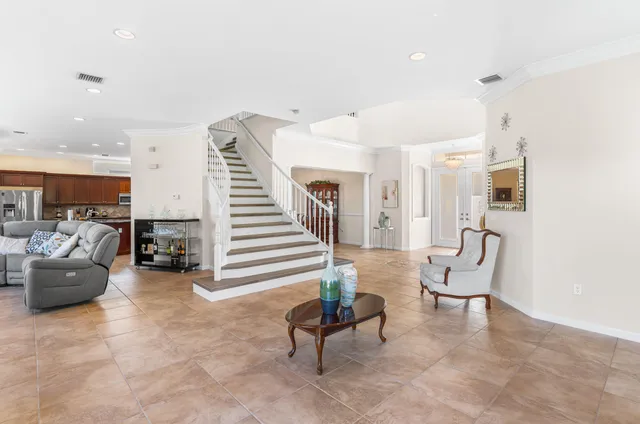 a living room with furniture and stairs