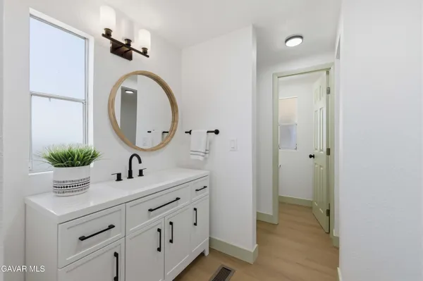 a bathroom with a glass shower door