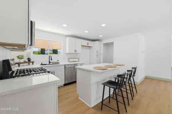 a kitchen with a table chairs stove and refrigerator