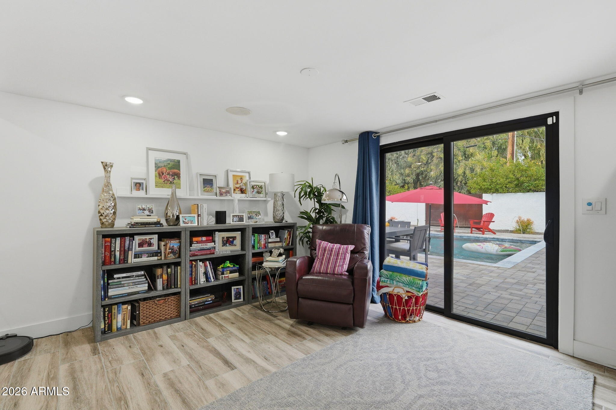 5149 North 34th Street Phoenix, AZ 85018 - Photo 27 of 70 a living room with lots of furniture and a book shelf