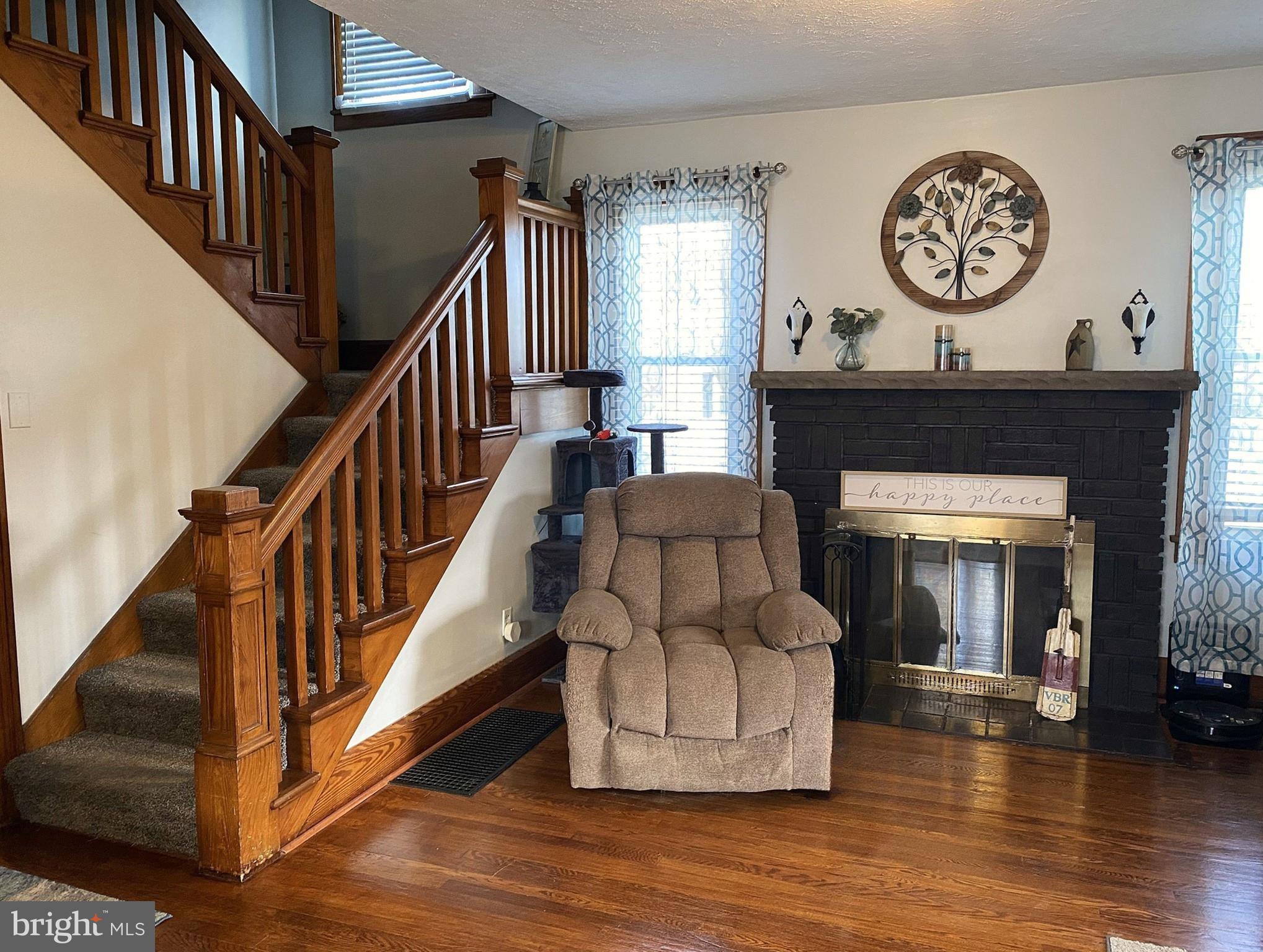 14103 Temple Street Ellerslie, MD 21529 - Photo 13 of 57 a living room with wooden floor and a fireplace