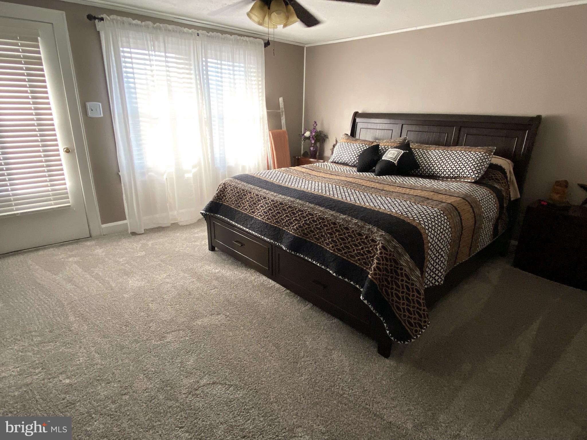 14103 Temple Street Ellerslie, MD 21529 - Photo 21 of 57 a bedroom with a bed and a chandelier