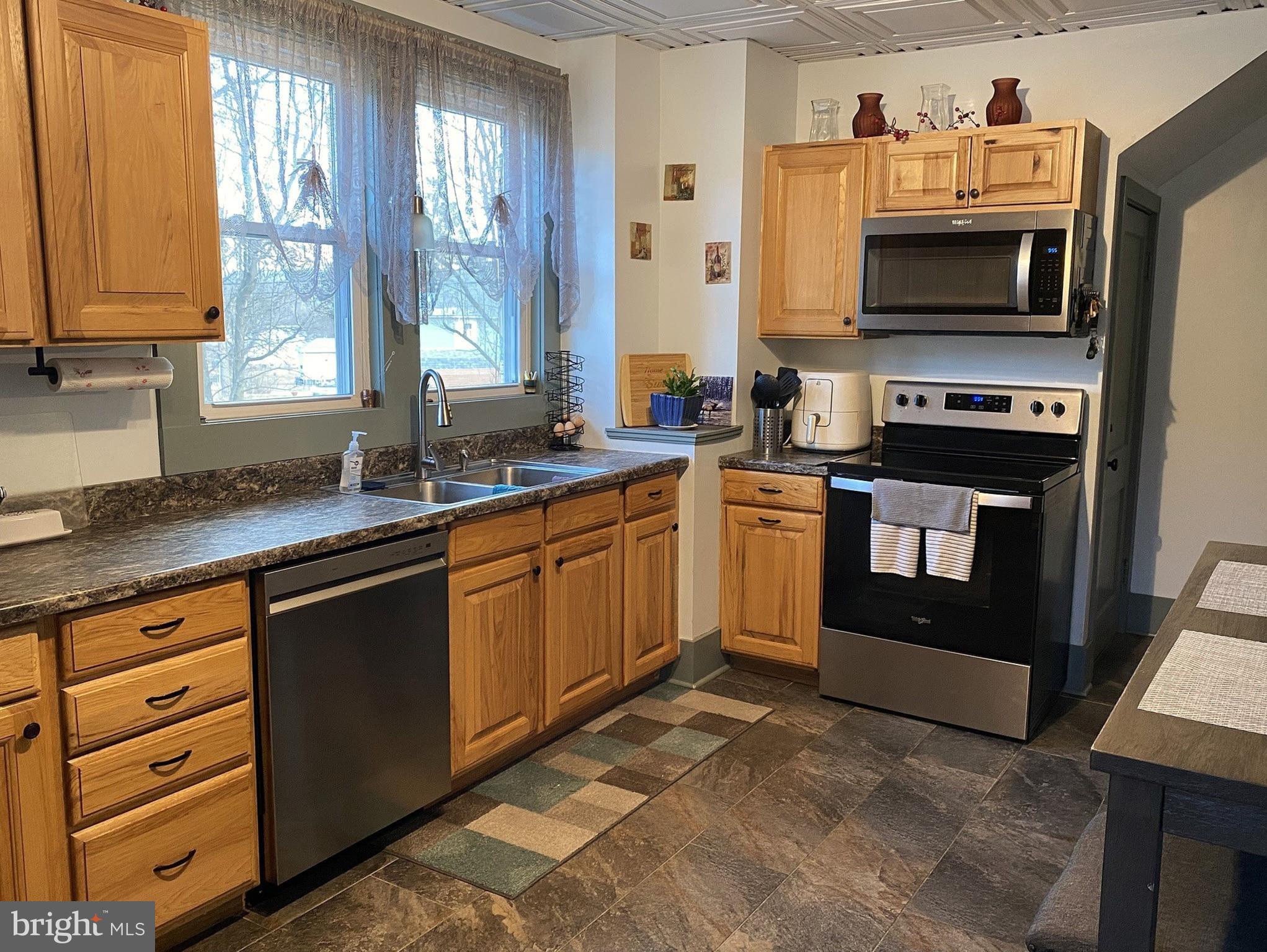 14103 Temple Street Ellerslie, MD 21529 - Photo 4 of 57 a kitchen with stainless steel appliances granite countertop a stove a sink and a microwave