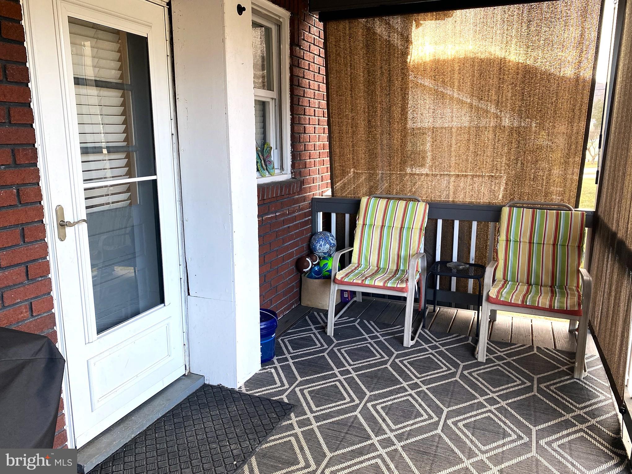 14103 Temple Street Ellerslie, MD 21529 - Photo 48 of 57 a view of a balcony with chairs and floor to ceiling window wooden floor