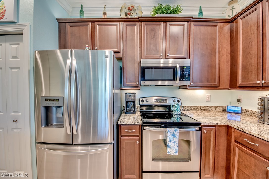 10420 Peso Del Rio Drive Fort Myers, FL 33908 - Photo 17 of 50 a kitchen with stainless steel appliances granite countertop a refrigerator a stove a sink and dishwasher
