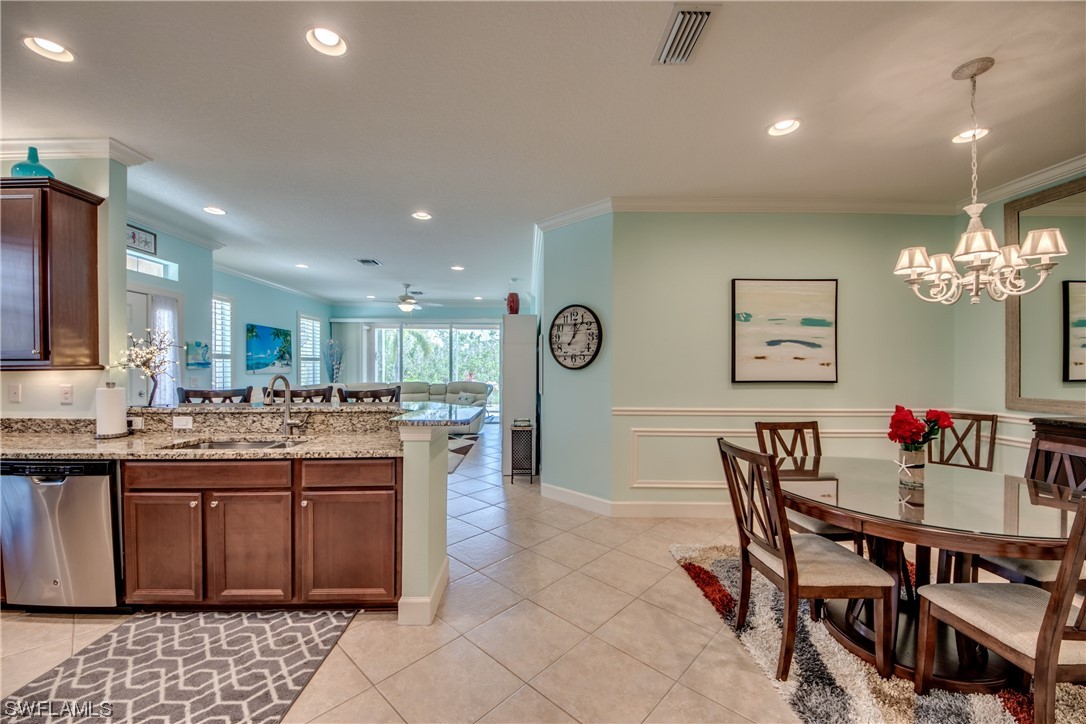 10420 Peso Del Rio Drive Fort Myers, FL 33908 - Photo 20 of 50 a kitchen with a dining table wooden cabinets and counter space