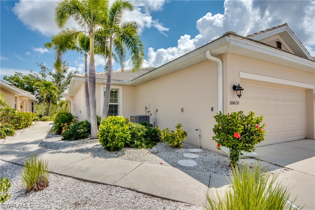 10420 Peso Del Rio Drive Fort Myers, FL 33908 - Photo 2 of 50 a vase of flowers sitting on a brick wall