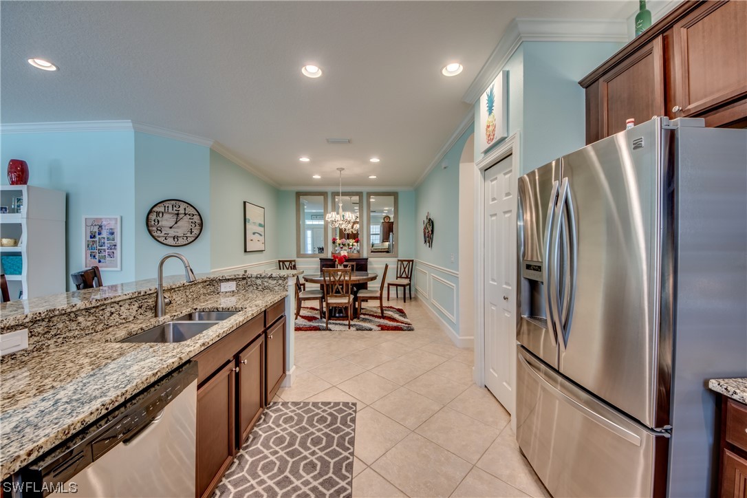 10420 Peso Del Rio Drive Fort Myers, FL 33908 - Photo 23 of 50 a kitchen with stainless steel appliances granite countertop a refrigerator and a sink