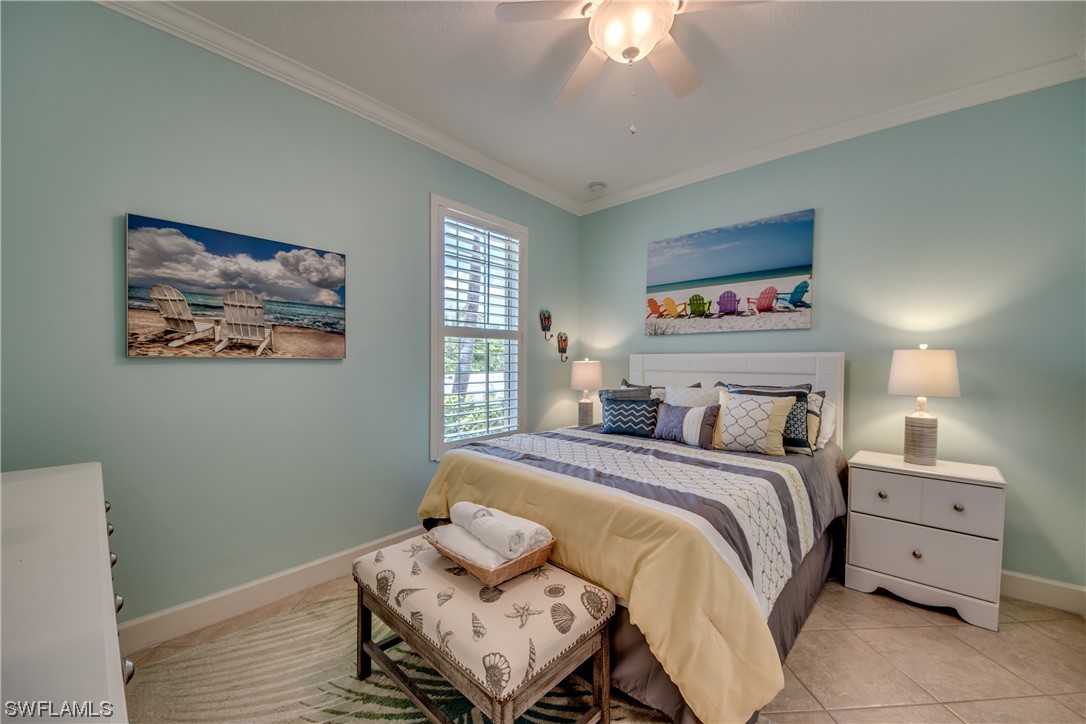 10420 Peso Del Rio Drive Fort Myers, FL 33908 - Photo 28 of 50 a bedroom with a bed and a chandelier