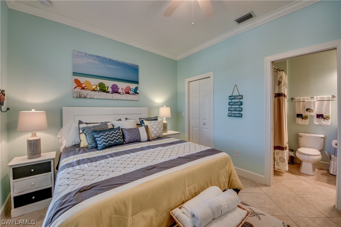 10420 Peso Del Rio Drive Fort Myers, FL 33908 - Photo 29 of 50 a bedroom with a bed and a lamp