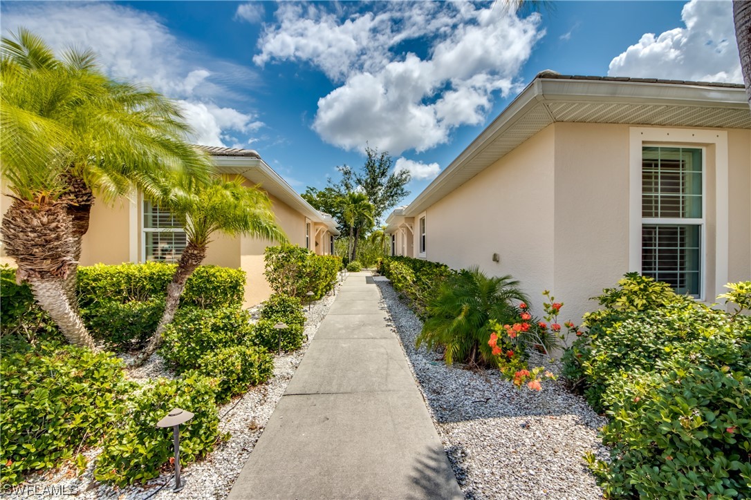 10420 Peso Del Rio Drive Fort Myers, FL 33908 - Photo 3 of 50 a view of a house with a flower garden