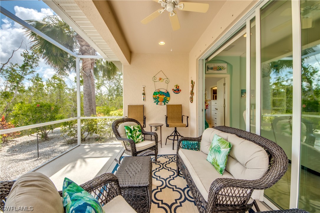 10420 Peso Del Rio Drive Fort Myers, FL 33908 - Photo 36 of 50 a view of a patio with couches table and chairs and potted plants