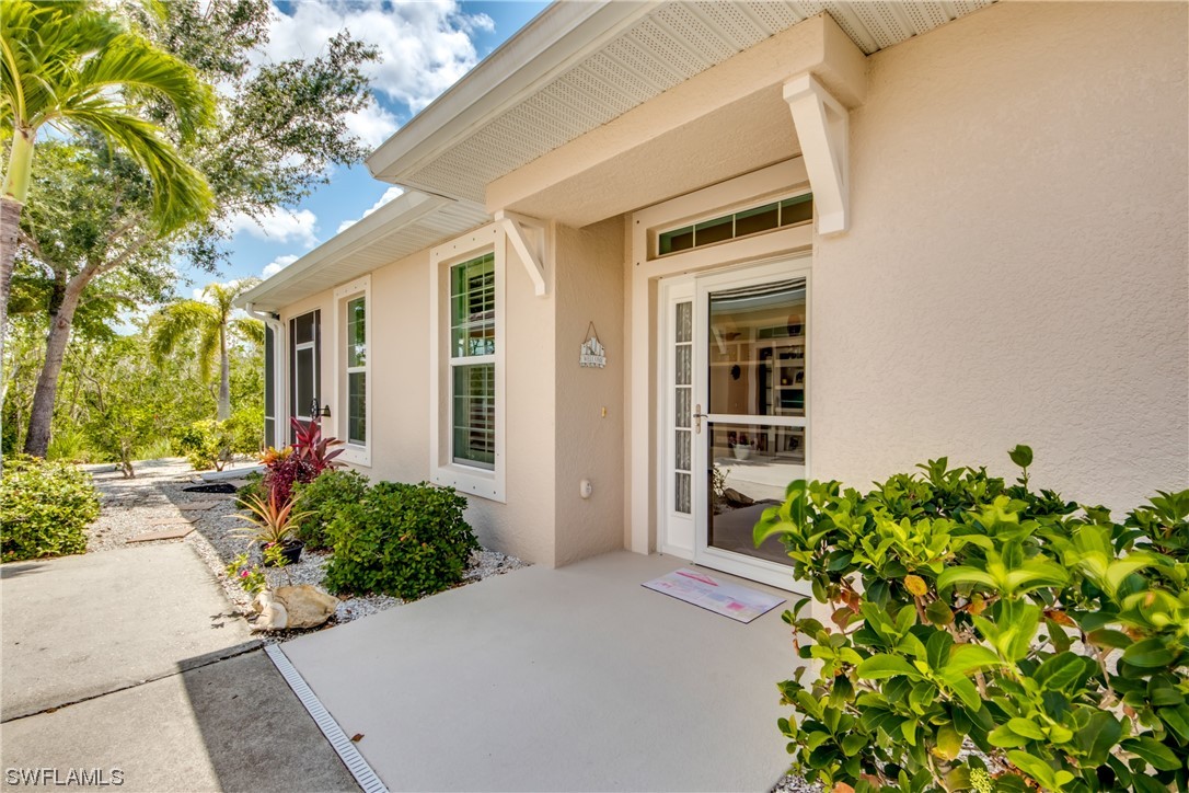 10420 Peso Del Rio Drive Fort Myers, FL 33908 - Photo 4 of 50 front view of a house with a yard