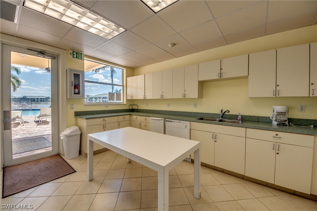 10420 Peso Del Rio Drive Fort Myers, FL 33908 - Photo 47 of 50 a kitchen with a sink a counter top space cabinets and stainless steel appliances