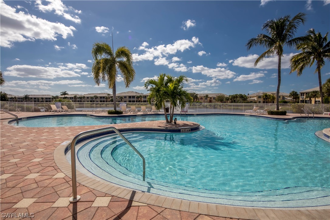 10420 Peso Del Rio Drive Fort Myers, FL 33908 - Photo 48 of 50 a view of swimming pool with outdoor seating and ocean view