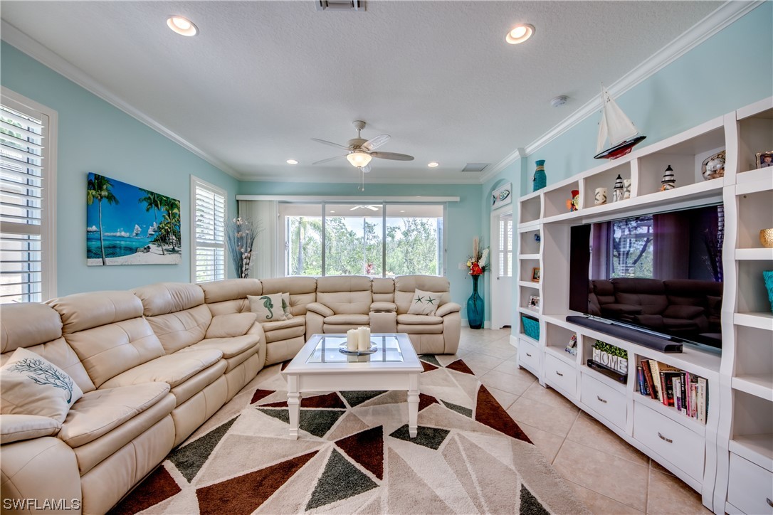 10420 Peso Del Rio Drive Fort Myers, FL 33908 - Photo 5 of 50 a living room with furniture and a flat screen tv