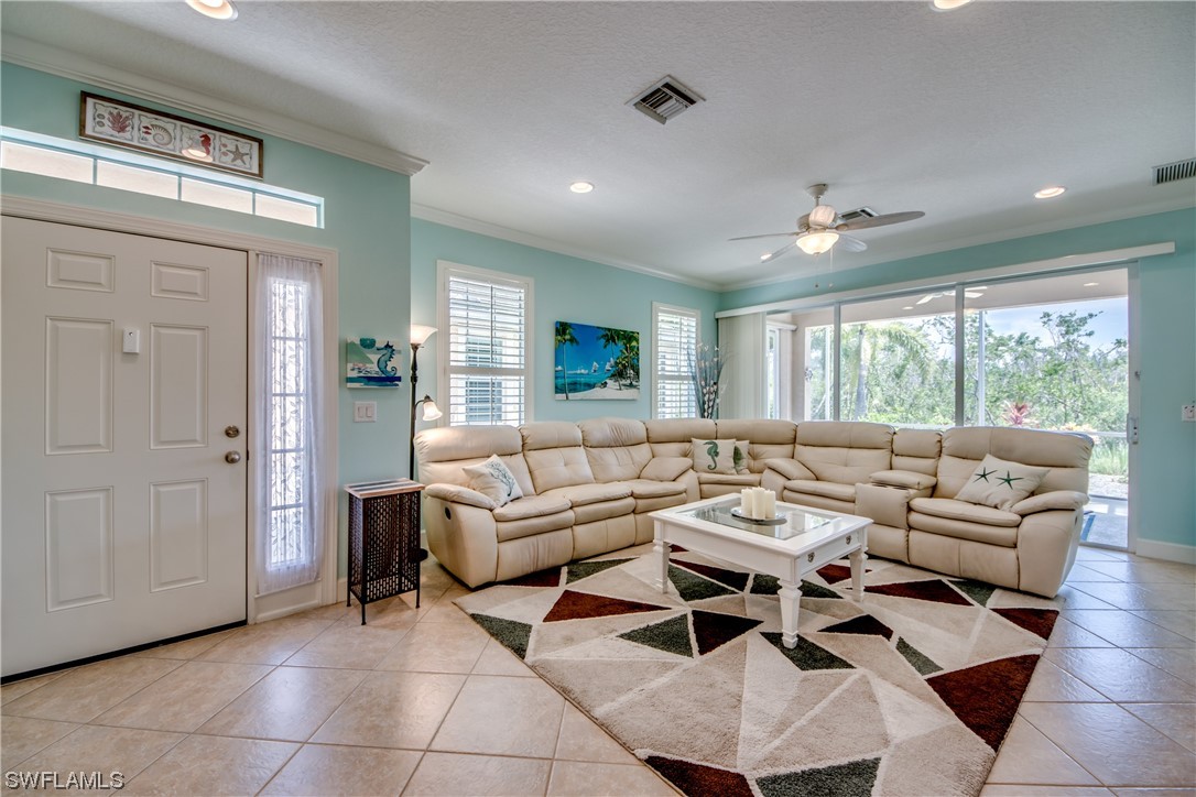 10420 Peso Del Rio Drive Fort Myers, FL 33908 - Photo 6 of 50 a living room with furniture and a large window