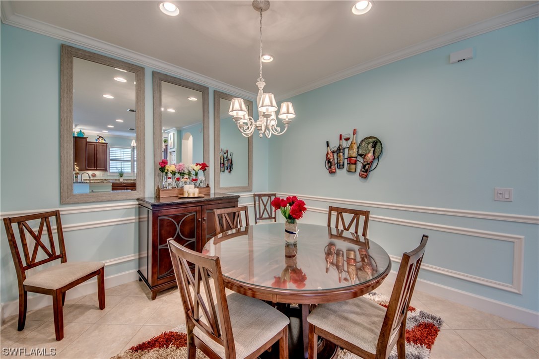 10420 Peso Del Rio Drive Fort Myers, FL 33908 - Photo 10 of 50 a view of a dining room with furniture and chandelier