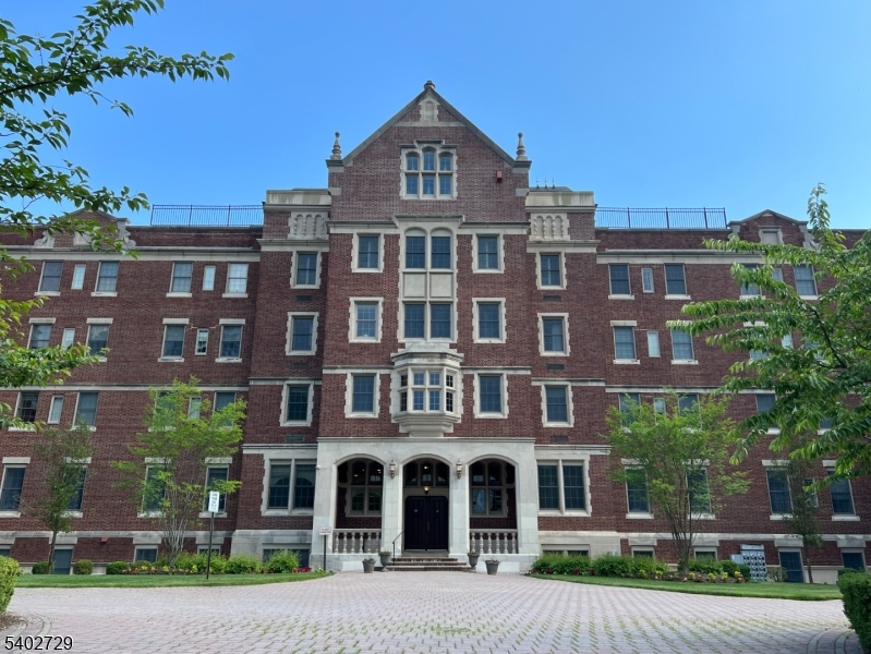 a front view of a residential apartment building with a yard