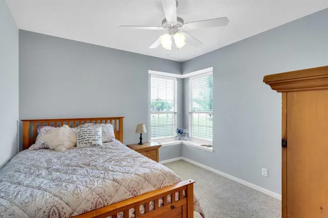 a bathroom with a double vanity sink a toilet and shower