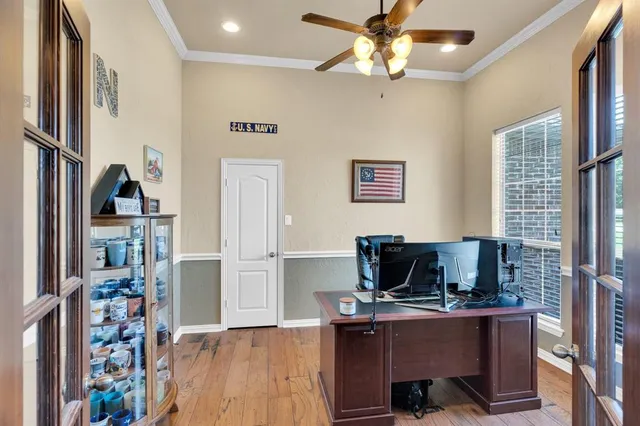 a bedroom with a bed chandelier and a window