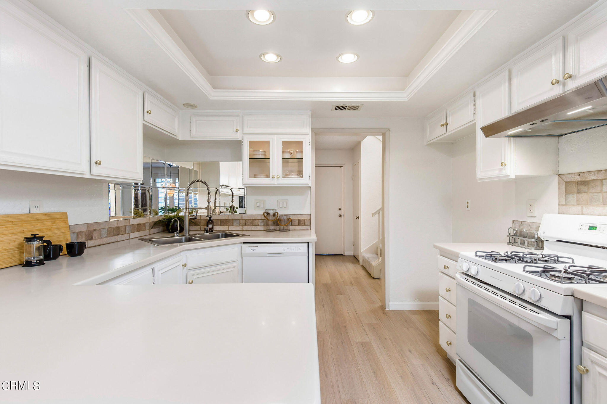 460 Fairview Avenue, Unit 12 Arcadia, CA 91007 - Photo 8 of 25 a kitchen with granite countertop a stove a sink dishwasher and a refrigerator with wooden floor