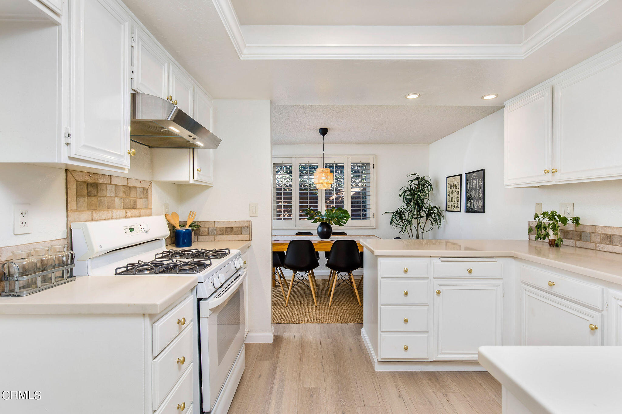 460 Fairview Avenue, Unit 12 Arcadia, CA 91007 - Photo 9 of 25 a kitchen with granite countertop a white stove top oven and white cabinets with wooden floor