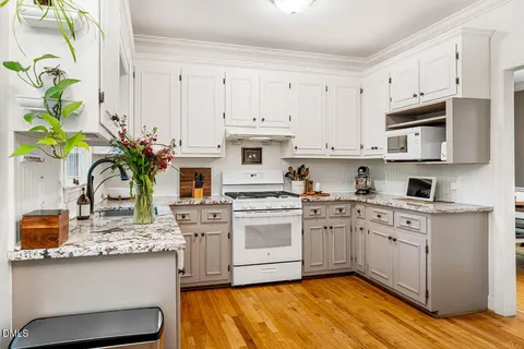 a kitchen with stainless steel appliances a refrigerator stove and cabinets
