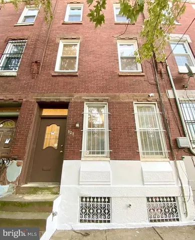 a view of a brick house with large windows