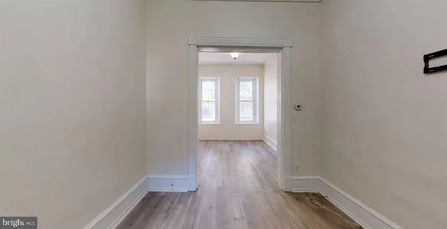 a view of a room with wooden floor and a window