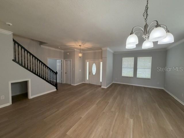 1885 Scrub Jay Road Apopka, FL 32703 - Photo 8 of 29 a view of an empty room with wooden floor and a window