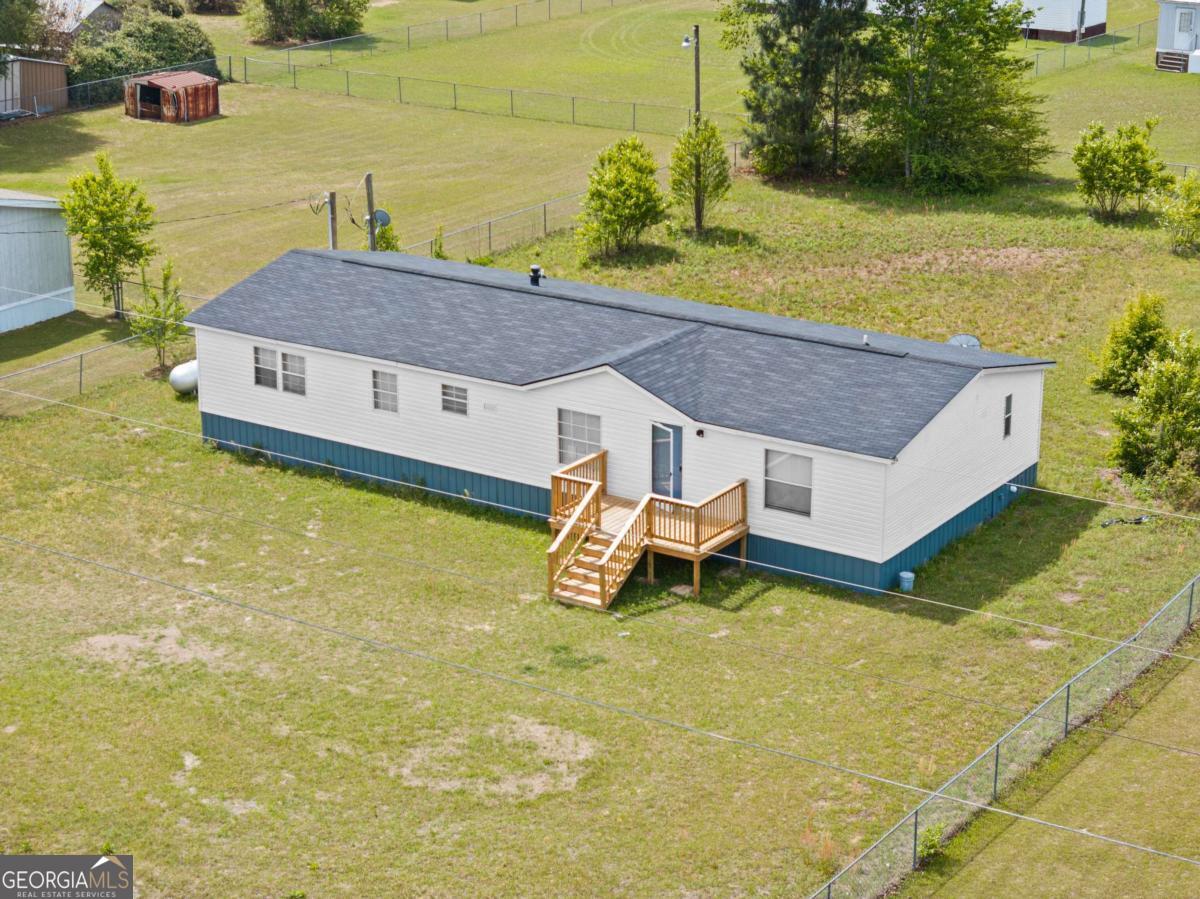 a aerial view of a house with swimming pool and a yard