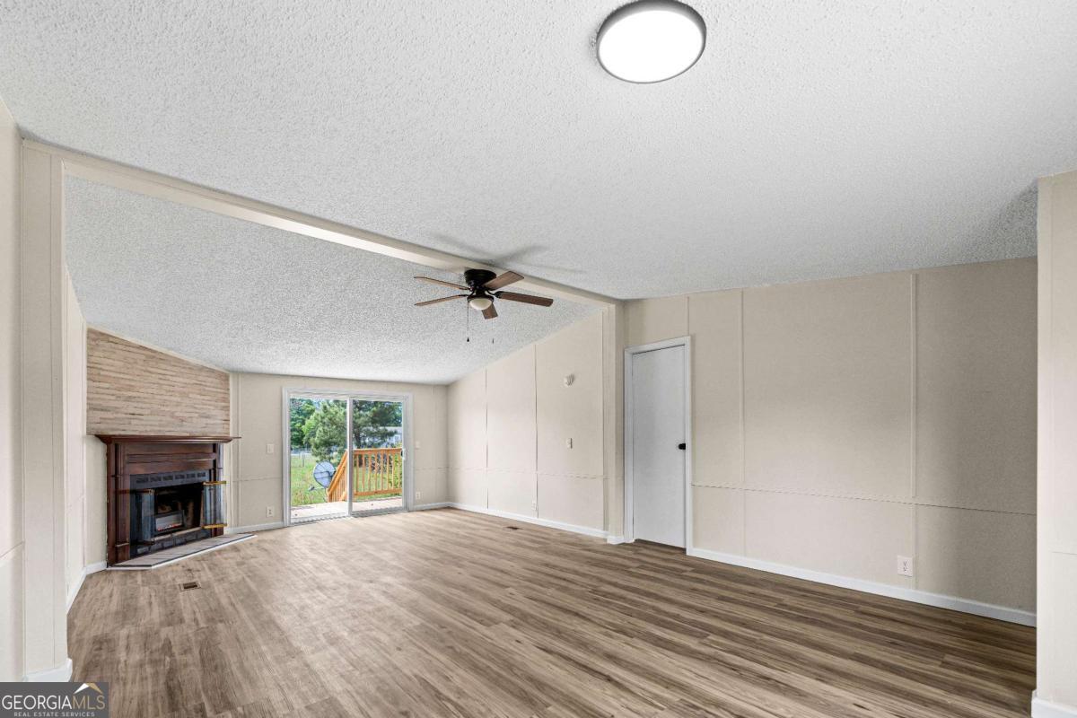 802 Allen Drive Vidalia, GA 30474 - Photo 16 of 29 a view of empty room with wooden floor and fan