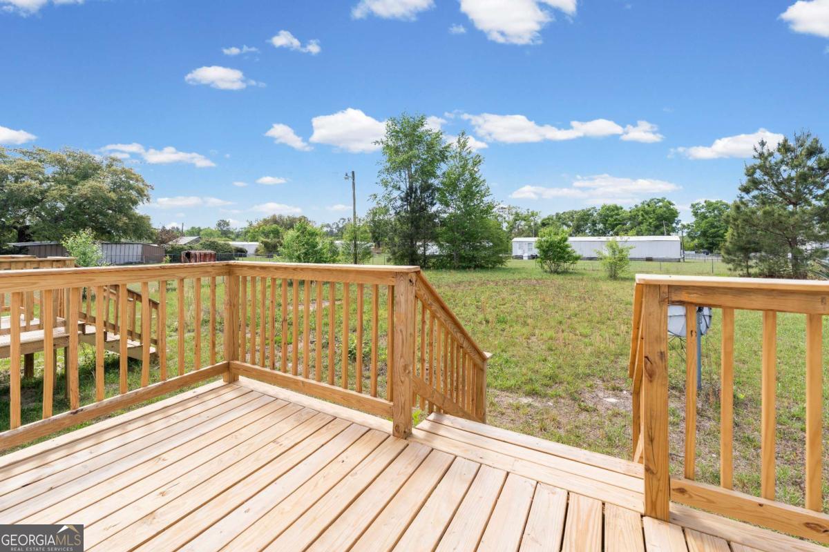 802 Allen Drive Vidalia, GA 30474 - Photo 17 of 29 a view of balcony with wooden floor & fence