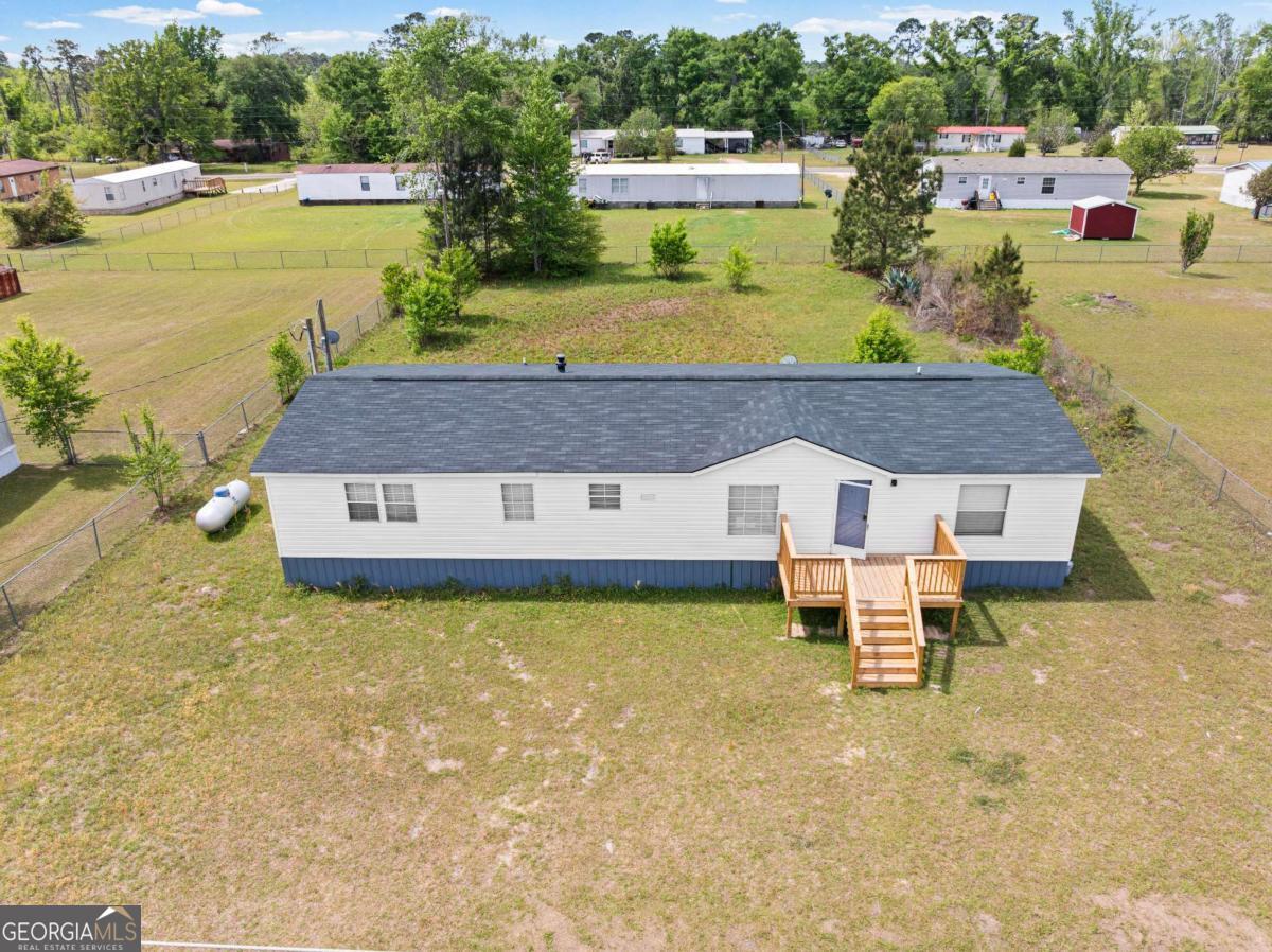 802 Allen Drive Vidalia, GA 30474 - Photo 2 of 29 a aerial view of a house with swimming pool and a yard
