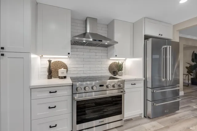 a spacious bedroom with a large bed and a potted plant