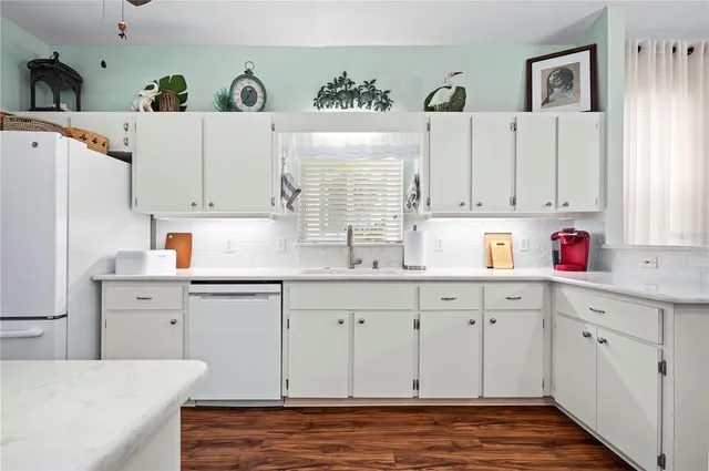 a kitchen with cabinets and window