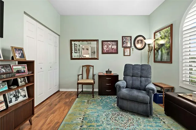 a living room with furniture and a book shelf