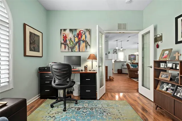 a living room with furniture and wooden floor